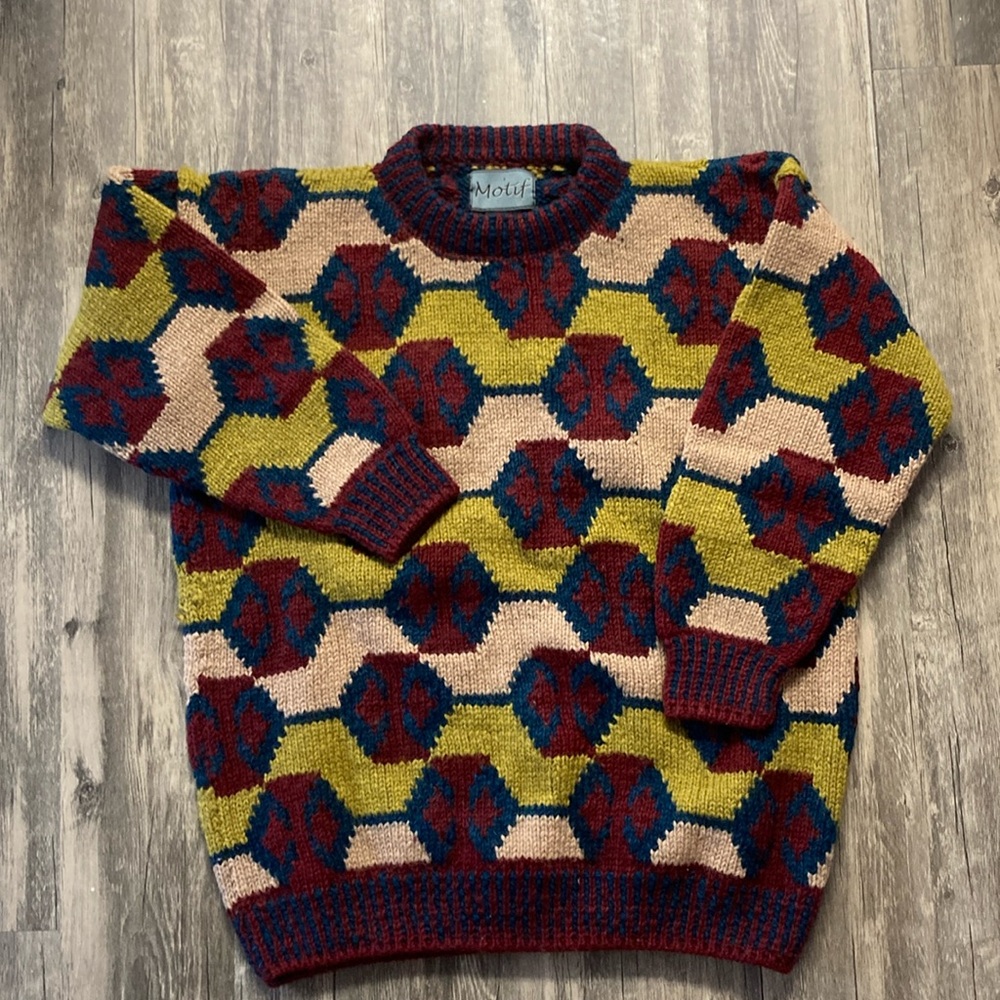 Motif 100% is wool hand knit sweater. Size L